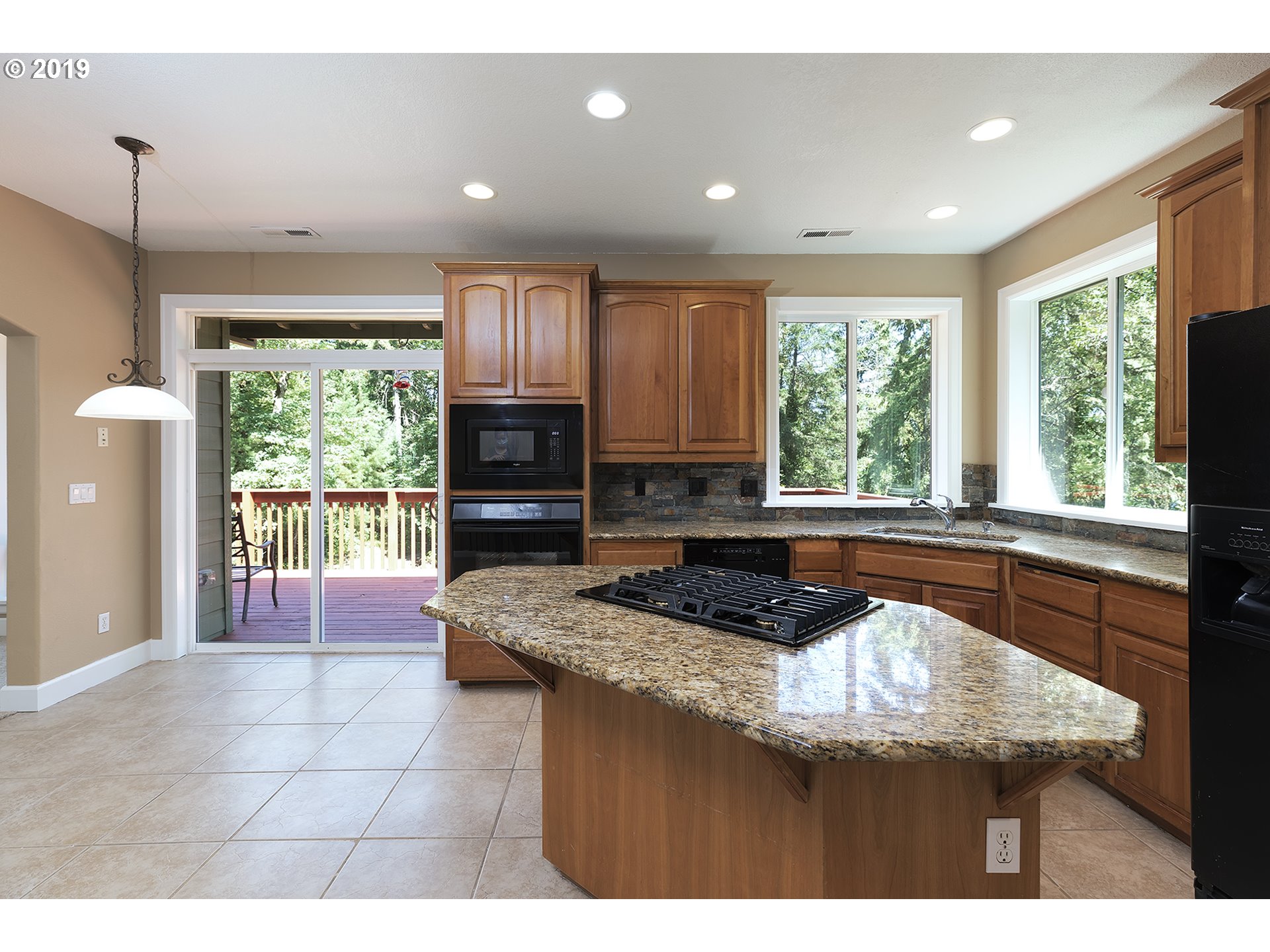 1925 Hillcrest Drive West Linn, OR 97068 - Photo 8 of 32 a kitchen with stainless steel appliances granite countertop a stove a sink and a microwave