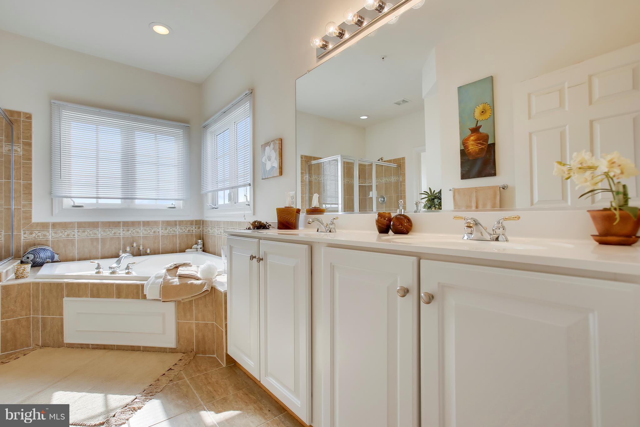 12312 Cypress Spring Road Clarksburg, MD 20871 - Photo 19 of 30 a view of a bathroom with a sink mirror and window