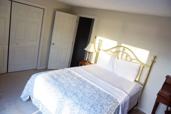 a bedroom with a bed and a mirror