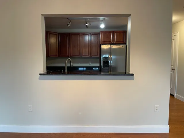 a view of a livingroom with wooden floor and a flat screen tv