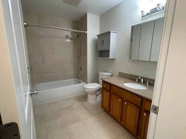 a bathroom with a bathtub and a shower