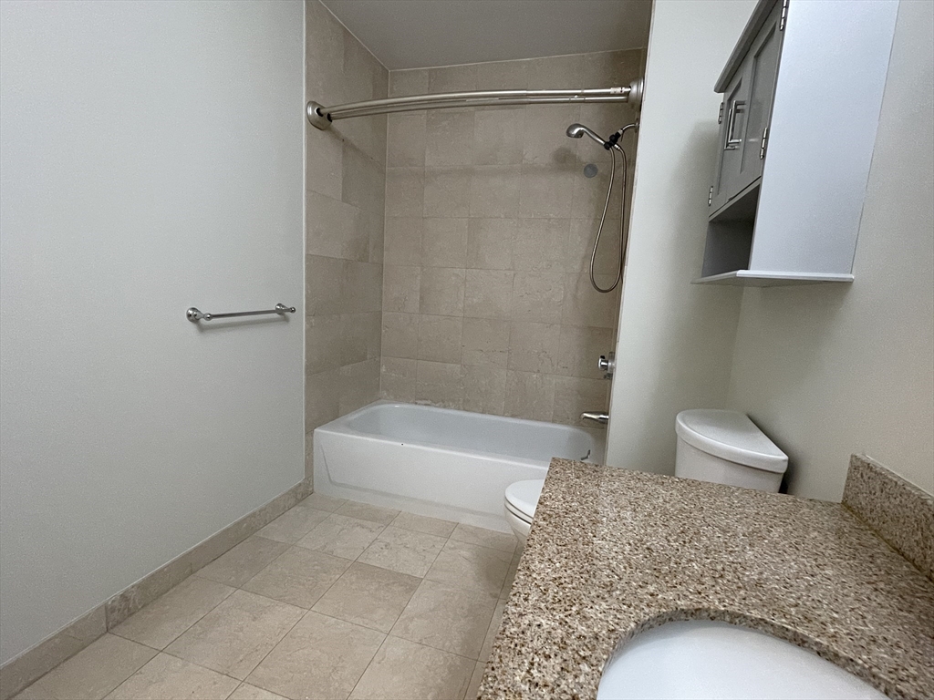 5170 Washington Street, Unit 3 Boston, MA 02132 - Photo 19 of 42 a bathroom with a bathtub and a shower