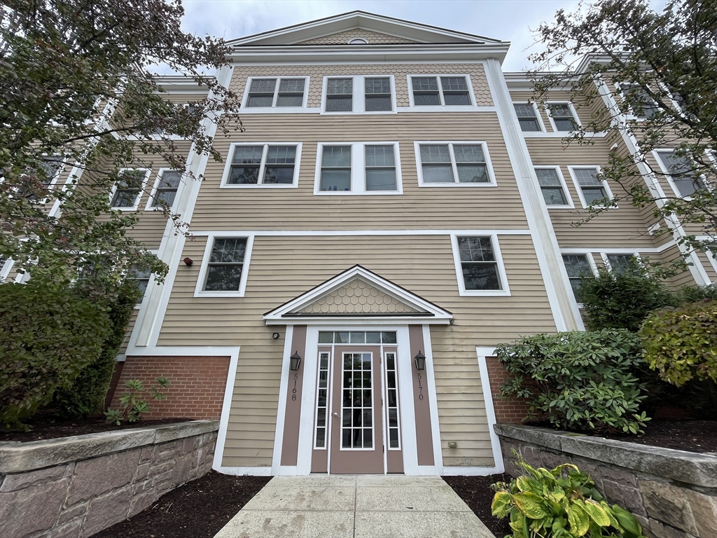5170 Washington Street, Unit 3 Boston, MA 02132 - Photo 2 of 42 a front view of a house with a garden