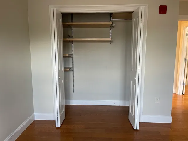 a view of walk in closet with empty racks