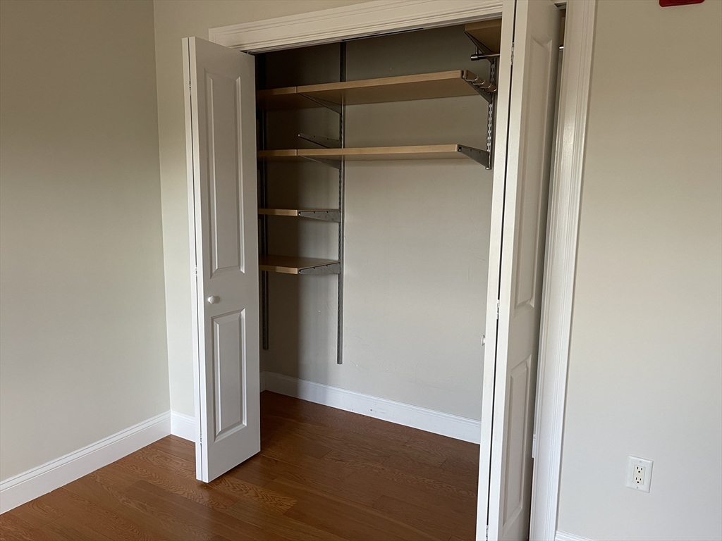 5170 Washington Street, Unit 3 Boston, MA 02132 - Photo 24 of 42 a view of walk in closet with empty racks