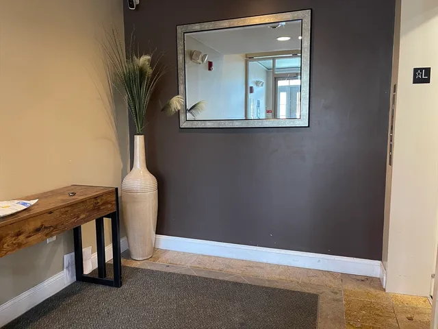 a view of a hallway with seating area