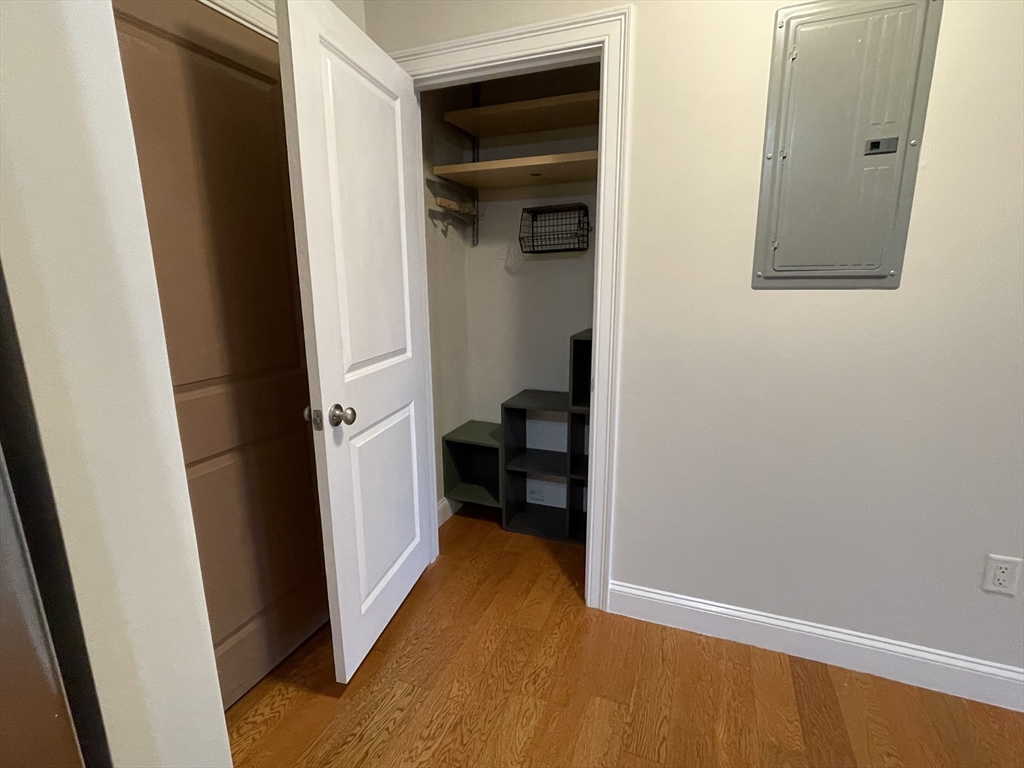 5170 Washington Street, Unit 3 Boston, MA 02132 - Photo 5 of 42 a view of a hallway with wooden floor and closet