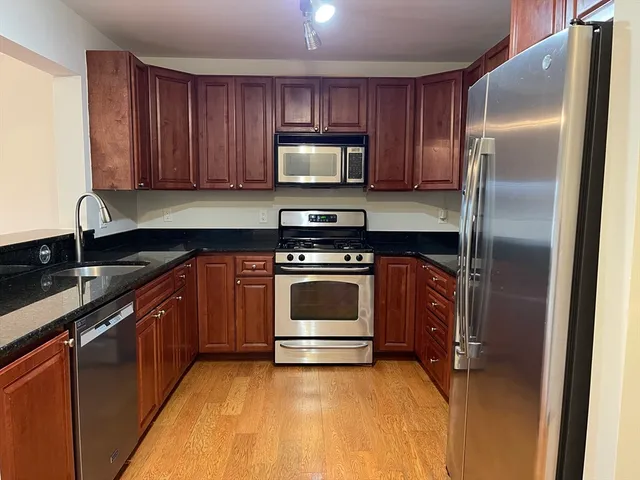 a kitchen with a sink stove and refrigerator