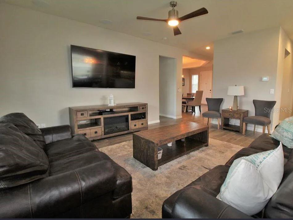 1049 Multiflora Loop Lutz, FL 33558 - Photo 12 of 49 a living room with furniture and a flat screen tv