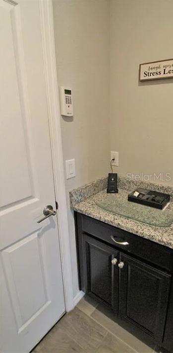 1049 Multiflora Loop Lutz, FL 33558 - Photo 19 of 49 a bathroom with a granite countertop sink and a mirror