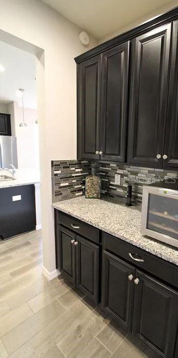 1049 Multiflora Loop Lutz, FL 33558 - Photo 20 of 49 a kitchen with stainless steel appliances granite countertop a sink a stove and a microwave oven