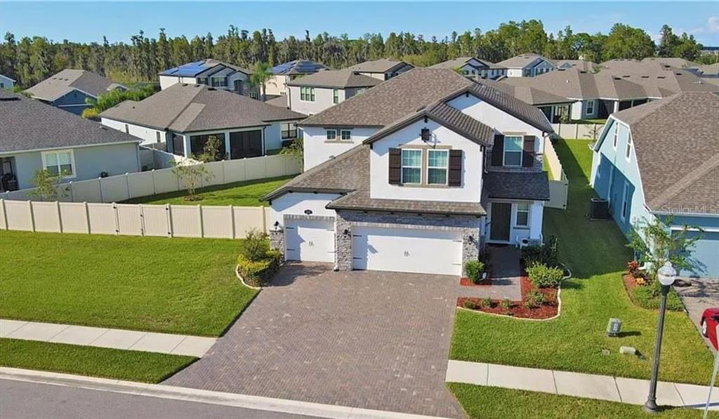 1049 Multiflora Loop Lutz, FL 33558 - Photo 2 of 49 a aerial view of a house with a yard
