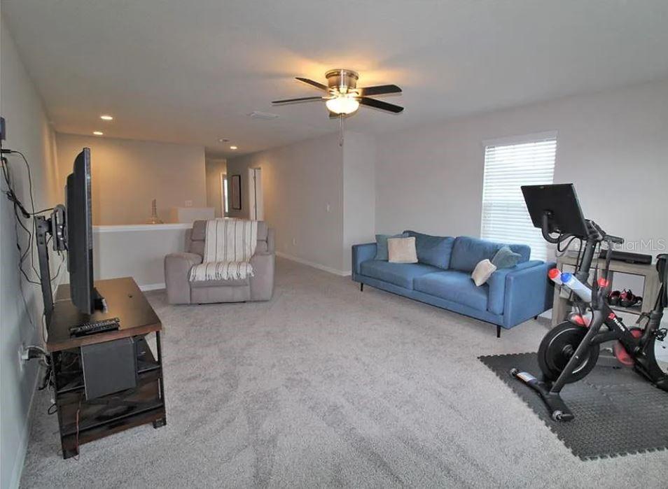 1049 Multiflora Loop Lutz, FL 33558 - Photo 23 of 49 a living room with furniture a air conditioner and a window