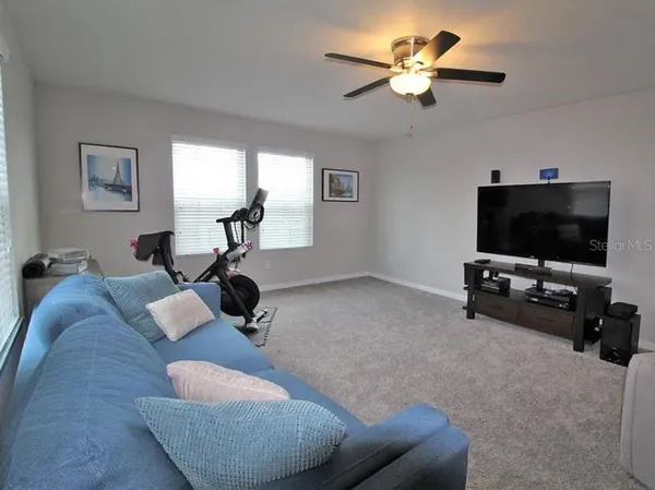 a living room with furniture a chandelier and a window