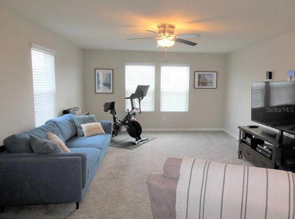 1049 Multiflora Loop Lutz, FL 33558 - Photo 25 of 49 a living room with furniture a chandelier and a window