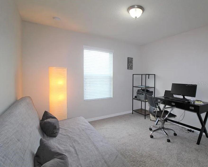 1049 Multiflora Loop Lutz, FL 33558 - Photo 29 of 49 a bedroom with a bed and a window