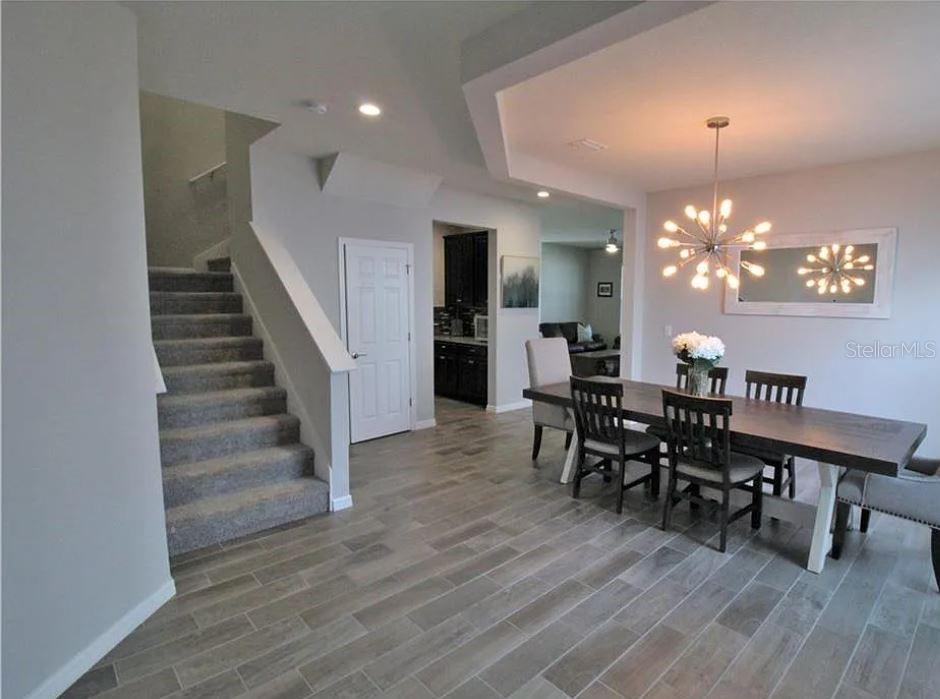 1049 Multiflora Loop Lutz, FL 33558 - Photo 3 of 49 a view of a dining room with furniture and wooden floor