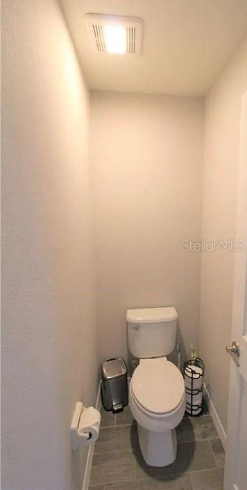 1049 Multiflora Loop Lutz, FL 33558 - Photo 38 of 49 a white toilet sitting next to a white wall