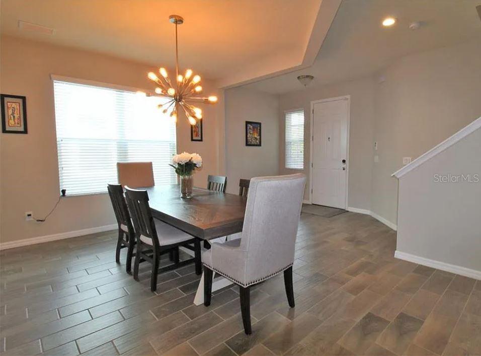 1049 Multiflora Loop Lutz, FL 33558 - Photo 4 of 49 a view of a dining room with furniture and chandelier