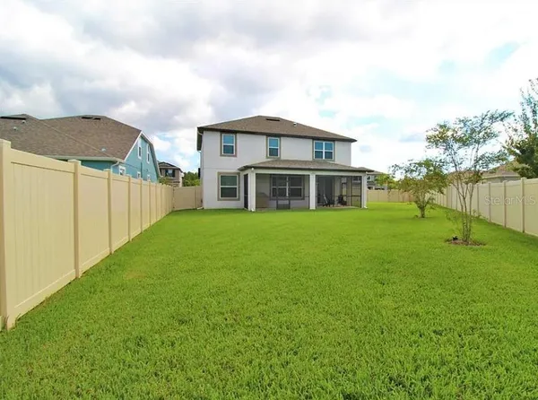 a front view of a house with a yard and outdoor seating