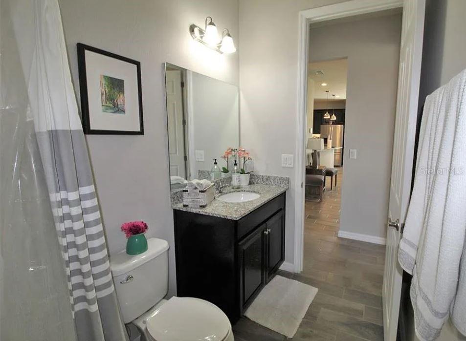 1049 Multiflora Loop Lutz, FL 33558 - Photo 5 of 49 a bathroom with a sink vanity and toilet