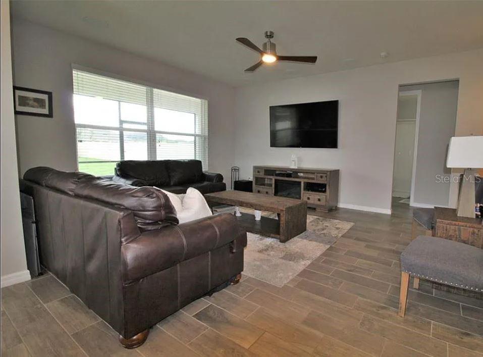 1049 Multiflora Loop Lutz, FL 33558 - Photo 10 of 49 a living room with furniture and a flat screen tv