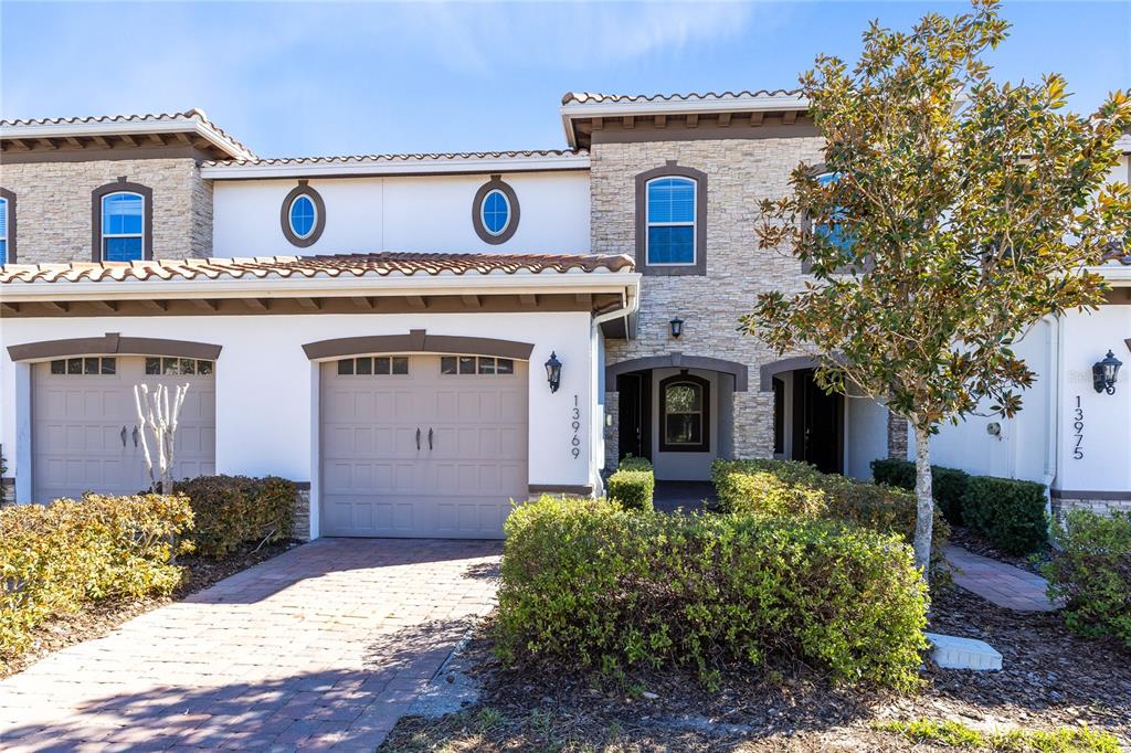 13969 Arclid Street Orlando, FL 32832 - Photo 22 of 29 a front view of a house with garden