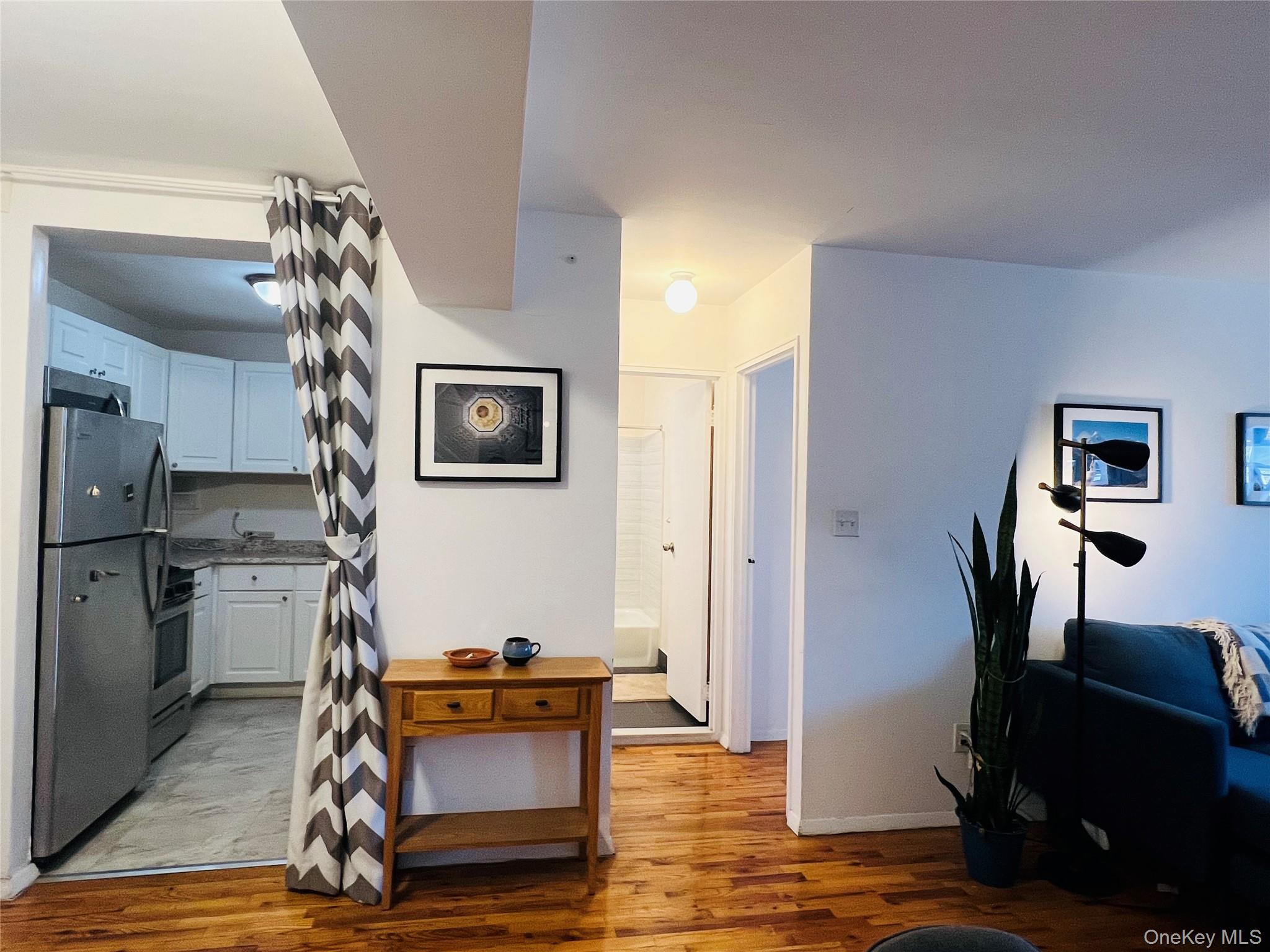58-03 Calloway Street, Unit 3MM Queens, NY 11368 - Photo 2 of 9 a view of a livingroom with furniture and gym equipment
