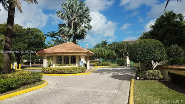 a front view of a house with garden and trees