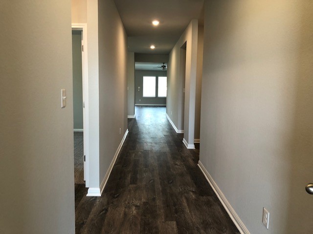 1237 Oak Chase Way Leander, TX 78641 - Photo 2 of 19 a view of a hallway with wooden floor and staircase