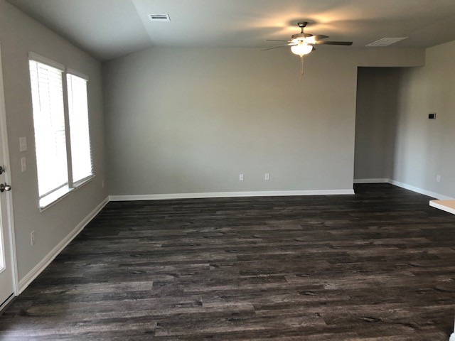1237 Oak Chase Way Leander, TX 78641 - Photo 3 of 19 a view of an empty room with wooden floor and a window