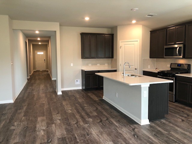 1237 Oak Chase Way Leander, TX 78641 - Photo 6 of 19 a large kitchen with stainless steel appliances a sink and a microwave