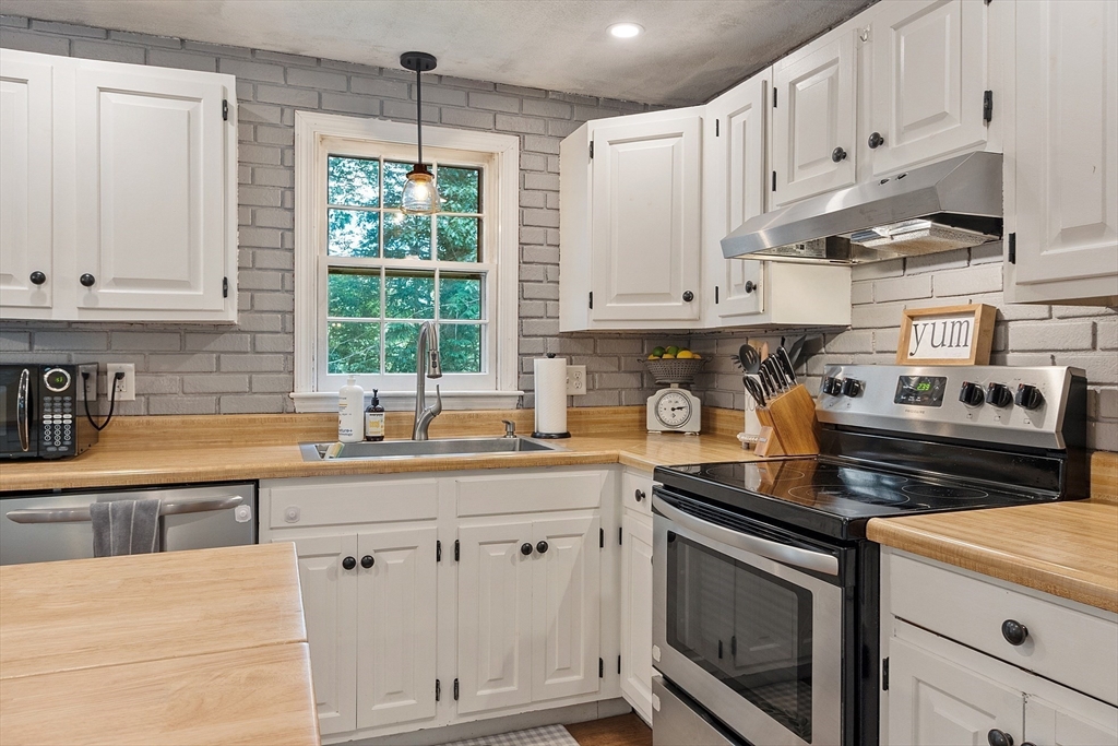 14 Emery Road Townsend, MA 01469 - Photo 14 of 31 a kitchen with granite countertop white cabinets and white appliances