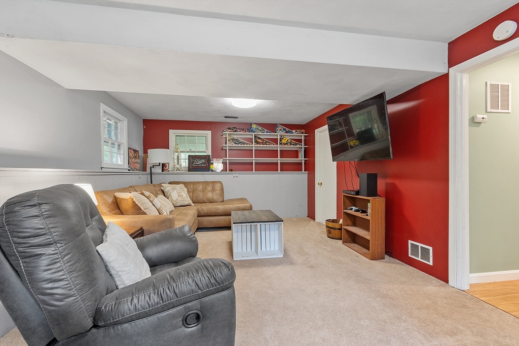 14 Emery Road Townsend, MA 01469 - Photo 25 of 31 a living room with furniture and a flat screen tv