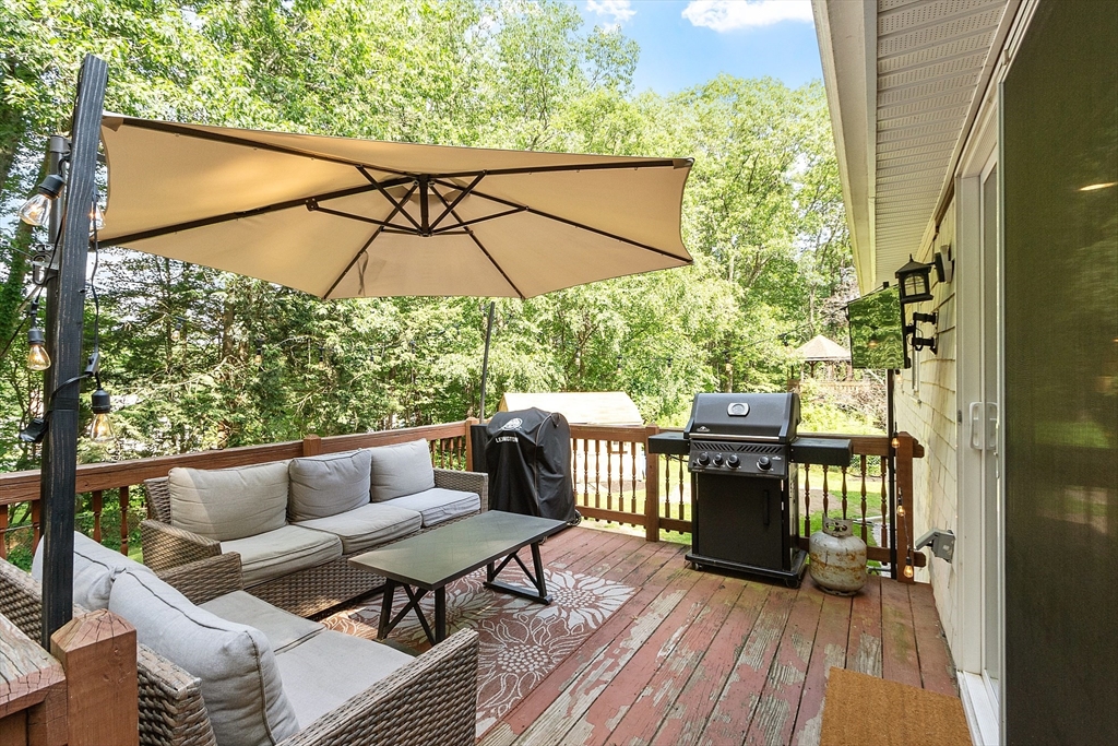 14 Emery Road Townsend, MA 01469 - Photo 6 of 31 a patio with wooden floor a yard a table and chairs
