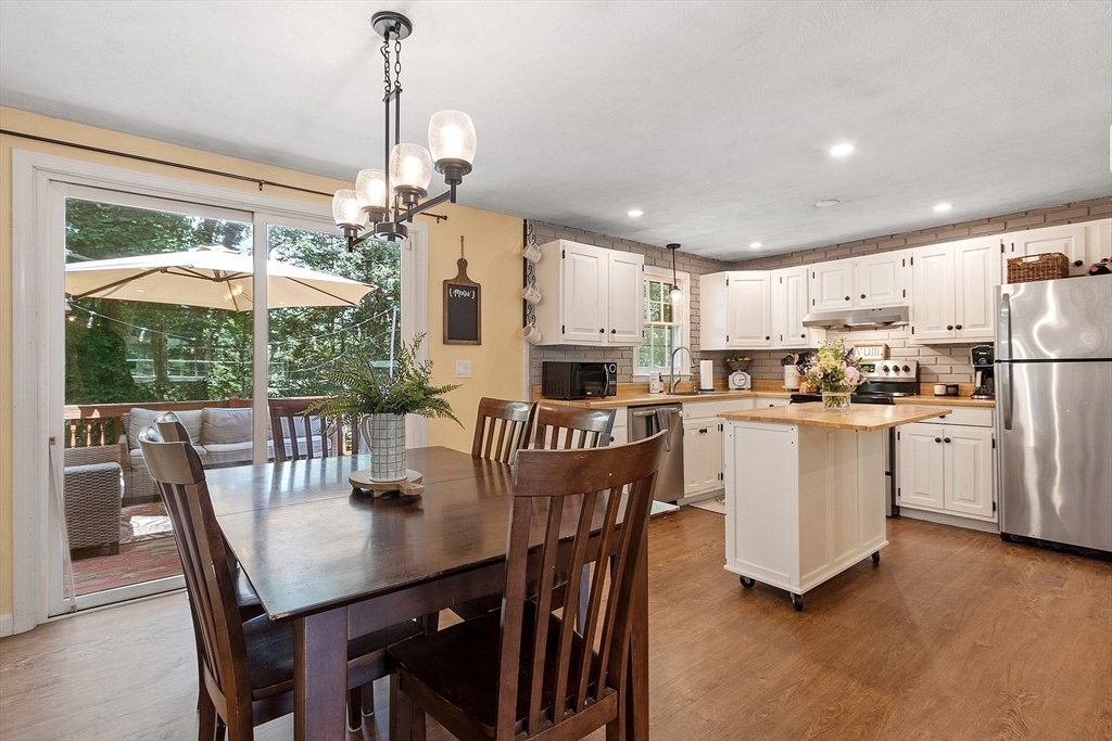 14 Emery Road Townsend, MA 01469 - Photo 10 of 31 a kitchen with white cabinets stainless steel appliances and dining table