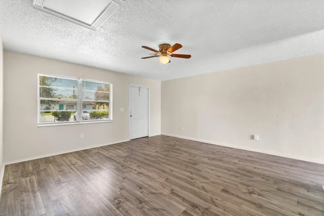 wooden floor in an empty room with a window