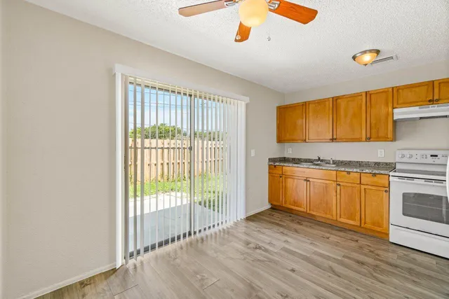 a view of a kitchen with wooden floor and a sink