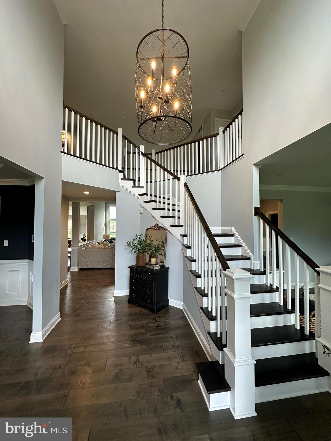 2084 Flowing Springs Road Chester Springs, PA 19425 - Photo 11 of 73 a view of staircase with lots of frames and a chandelier