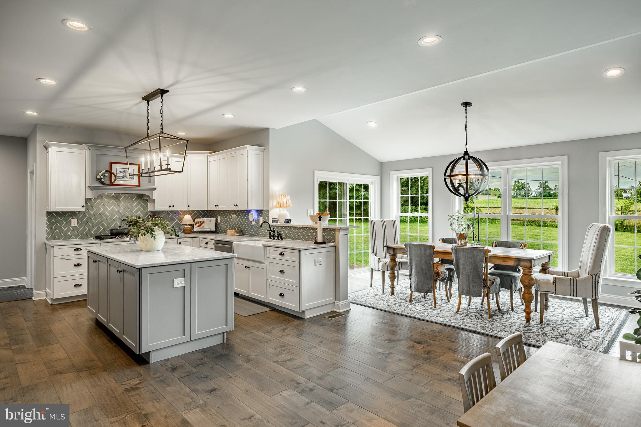 2084 Flowing Springs Road Chester Springs, PA 19425 - Photo 15 of 73 a kitchen with stainless steel appliances granite countertop a stove oven and a dining table with white cabinets