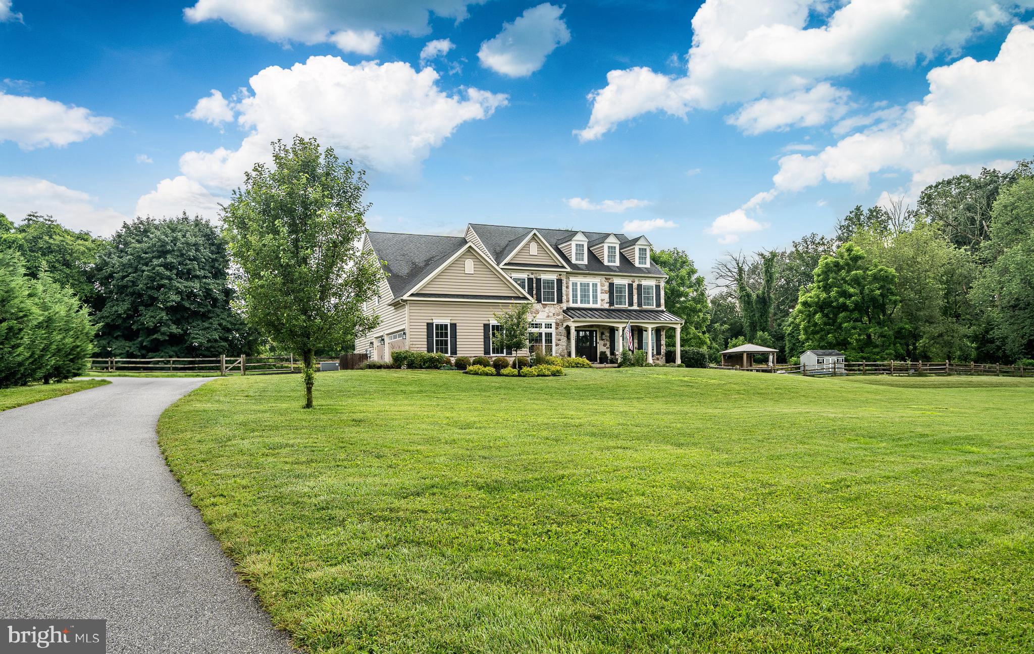 2084 Flowing Springs Road Chester Springs, PA 19425 - Photo 4 of 73 a front view of a house with a garden