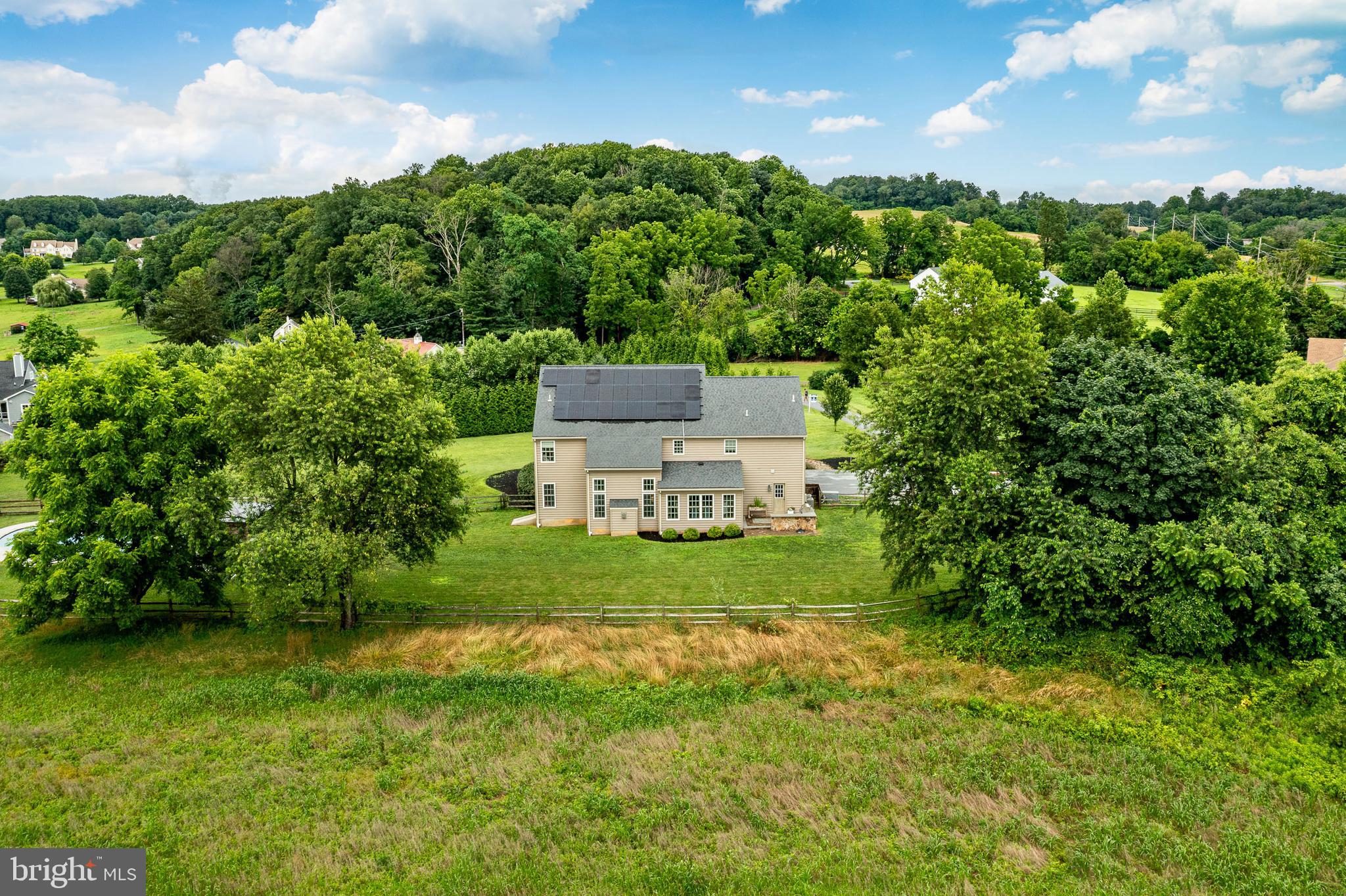 2084 Flowing Springs Road Chester Springs, PA 19425 - Photo 63 of 73 a view of a big yard next to a house