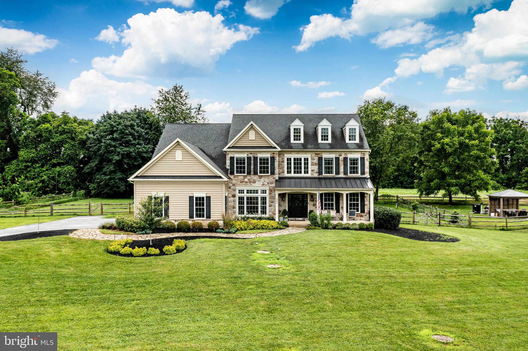 2084 Flowing Springs Road Chester Springs, PA 19425 - Photo 67 of 73 a front view of a house with garden and trees