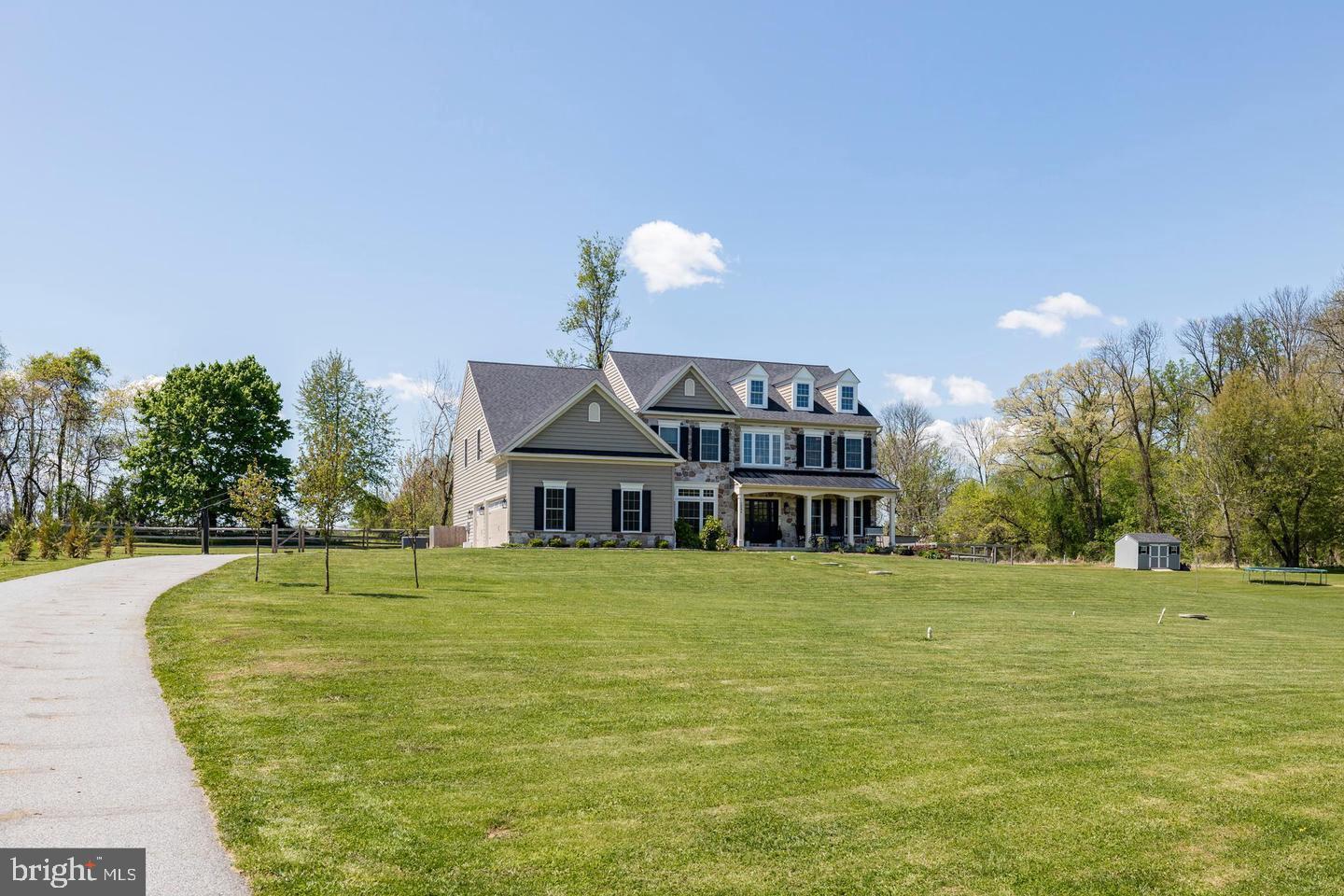 2084 Flowing Springs Road Chester Springs, PA 19425 - Photo 68 of 73 a front view of a house with a garden