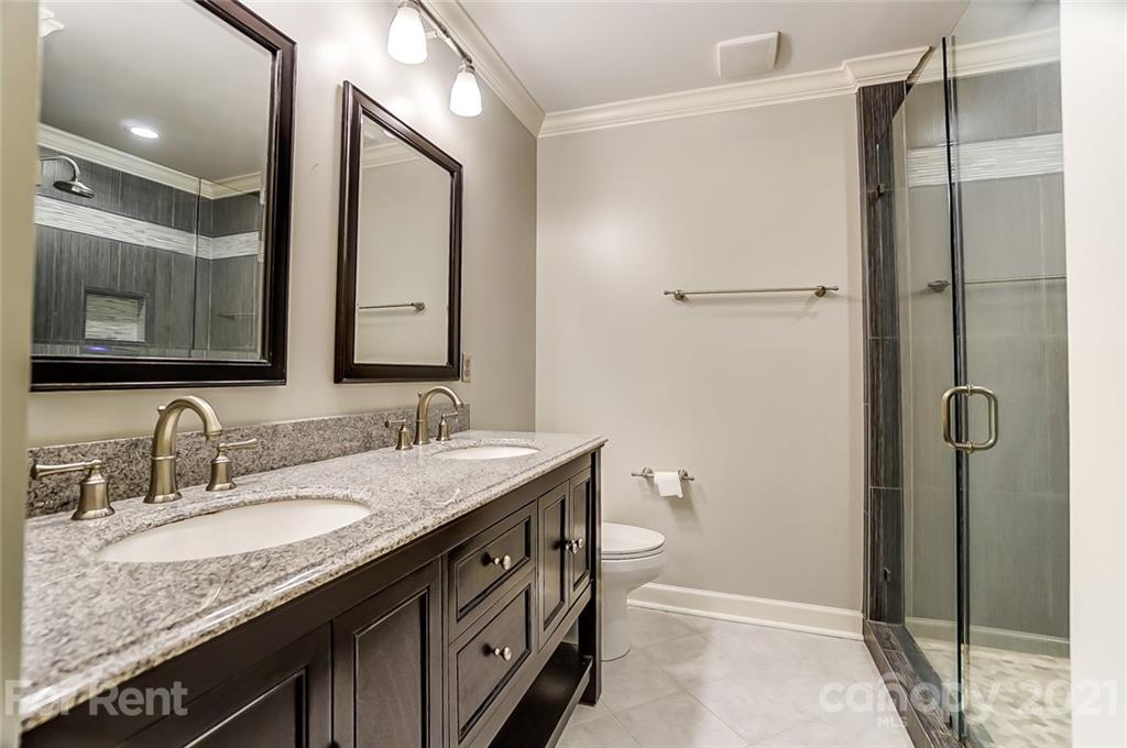 416 Queens Road Charlotte, NC 28207 - Photo 16 of 25 a bathroom with a granite countertop sink toilet and shower