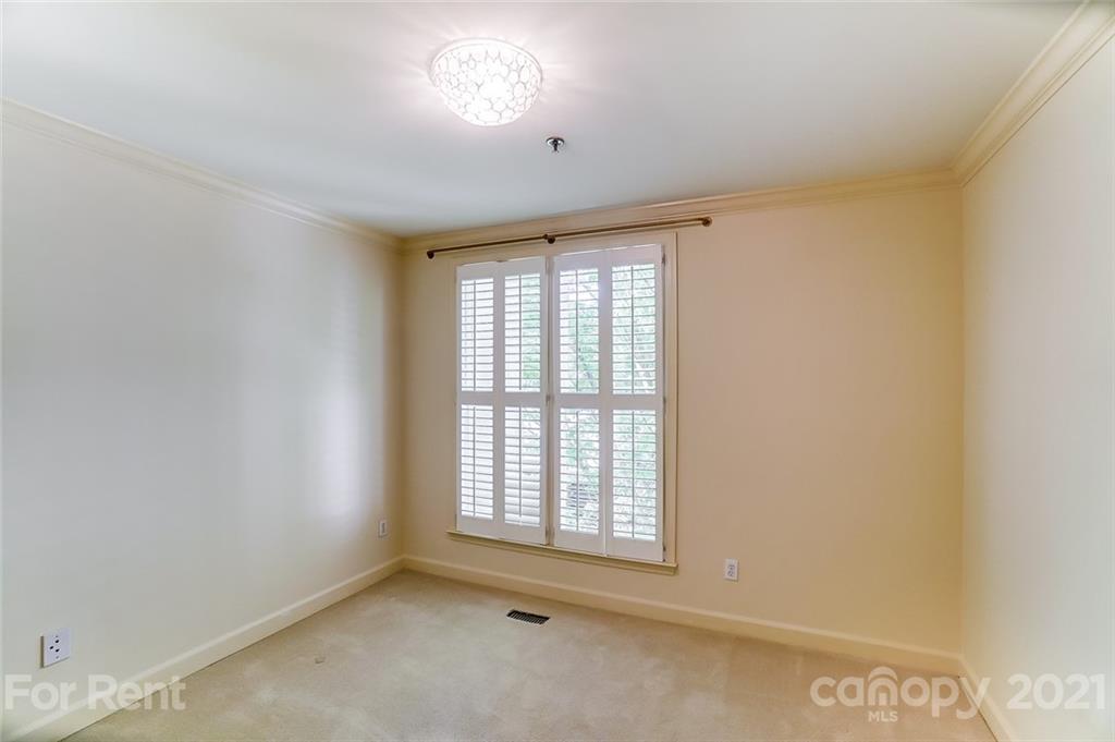 416 Queens Road Charlotte, NC 28207 - Photo 17 of 25 a view of an empty room with a window