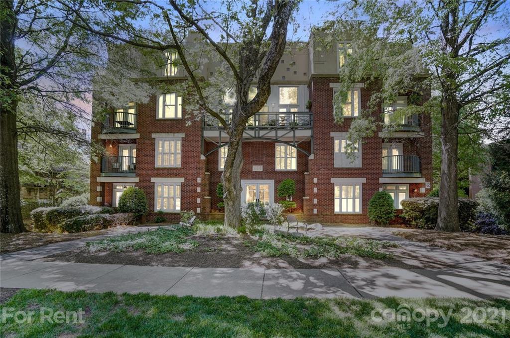416 Queens Road Charlotte, NC 28207 - Photo 24 of 25 a view of a brick building next to a yard