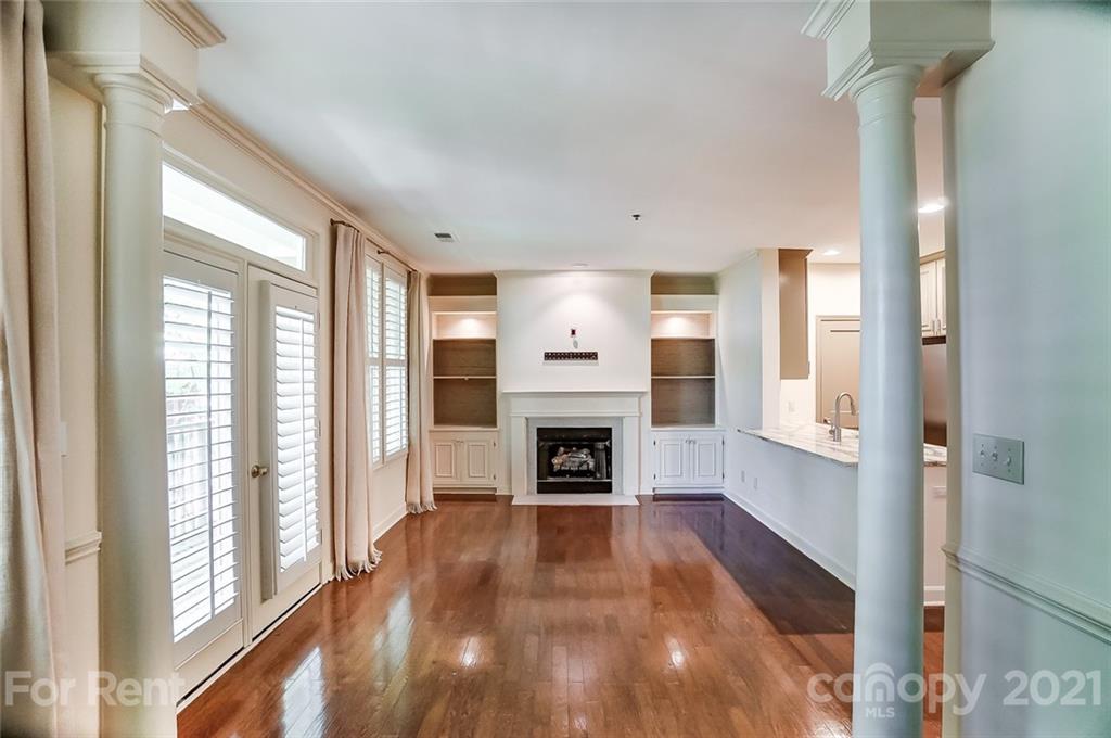 416 Queens Road Charlotte, NC 28207 - Photo 4 of 25 a view of a livingroom with a fireplace wooden floor and window