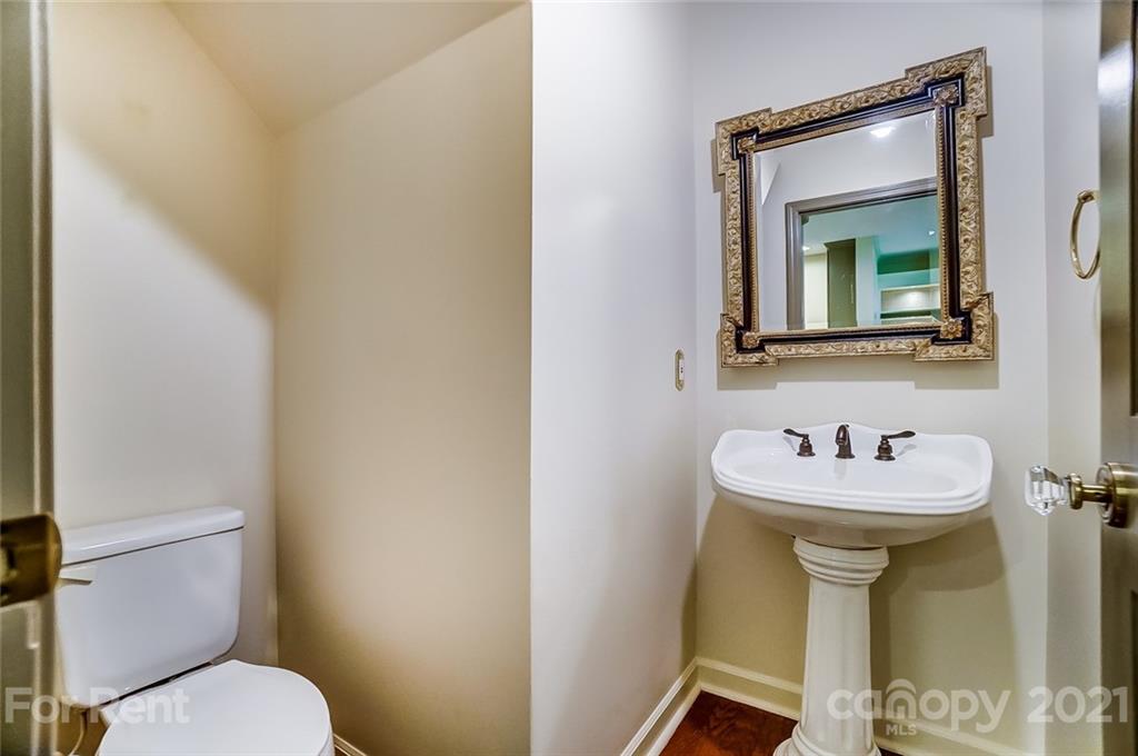 416 Queens Road Charlotte, NC 28207 - Photo 9 of 25 a bathroom with a sink mirror toilet and a mirror
