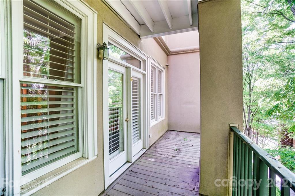416 Queens Road Charlotte, NC 28207 - Photo 10 of 25 a view of a balcony with wooden floor and fence